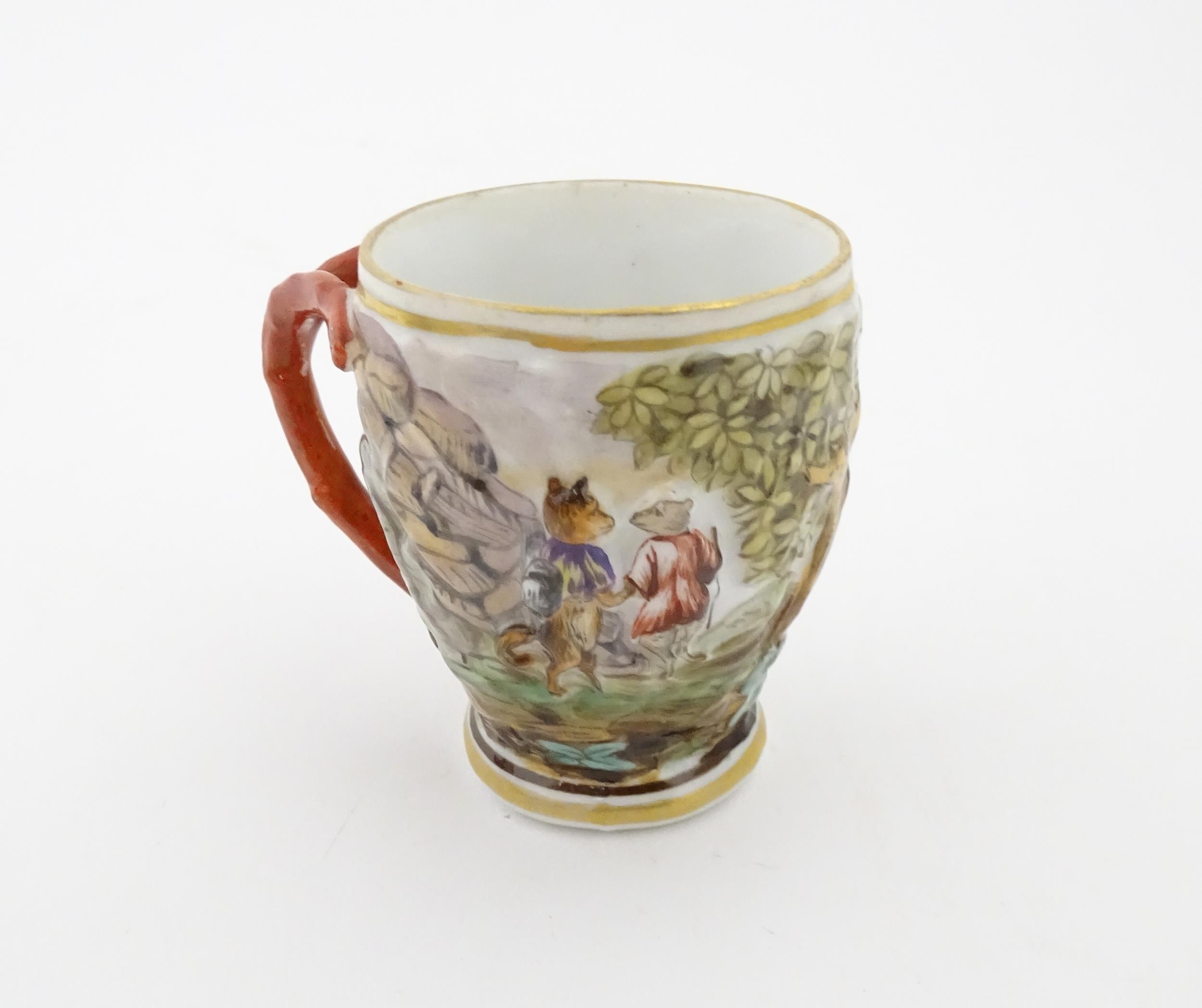 A Continental coffee cup decorated in relief with animals in a landscape. Marked under with - Image 4 of 6