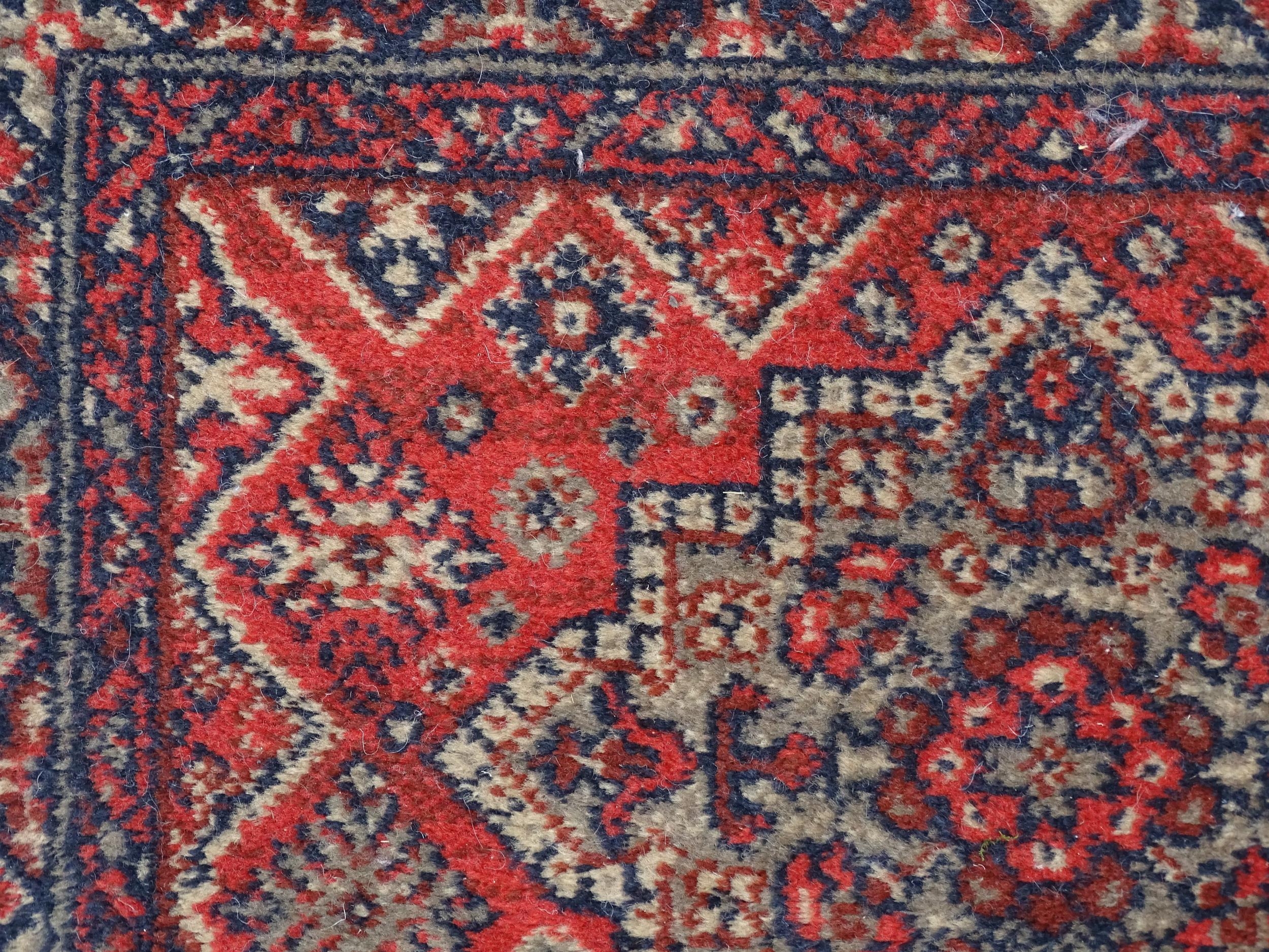 Carpet / Rug : A red ground runner with repeating motifs to centre, bordered by geometric banding. - Image 5 of 8