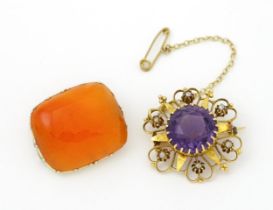 A Victorian yellow metal brooch of stylised star form set with amethyst seed pearl detail.