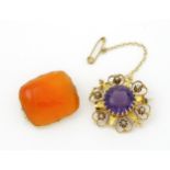 A Victorian yellow metal brooch of stylised star form set with amethyst seed pearl detail.