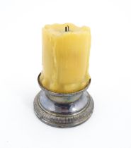 A 20thC French novelty table lighter modelled as a candle with a silver plate base. Marked under