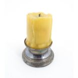 A 20thC French novelty table lighter modelled as a candle with a silver plate base. Marked under