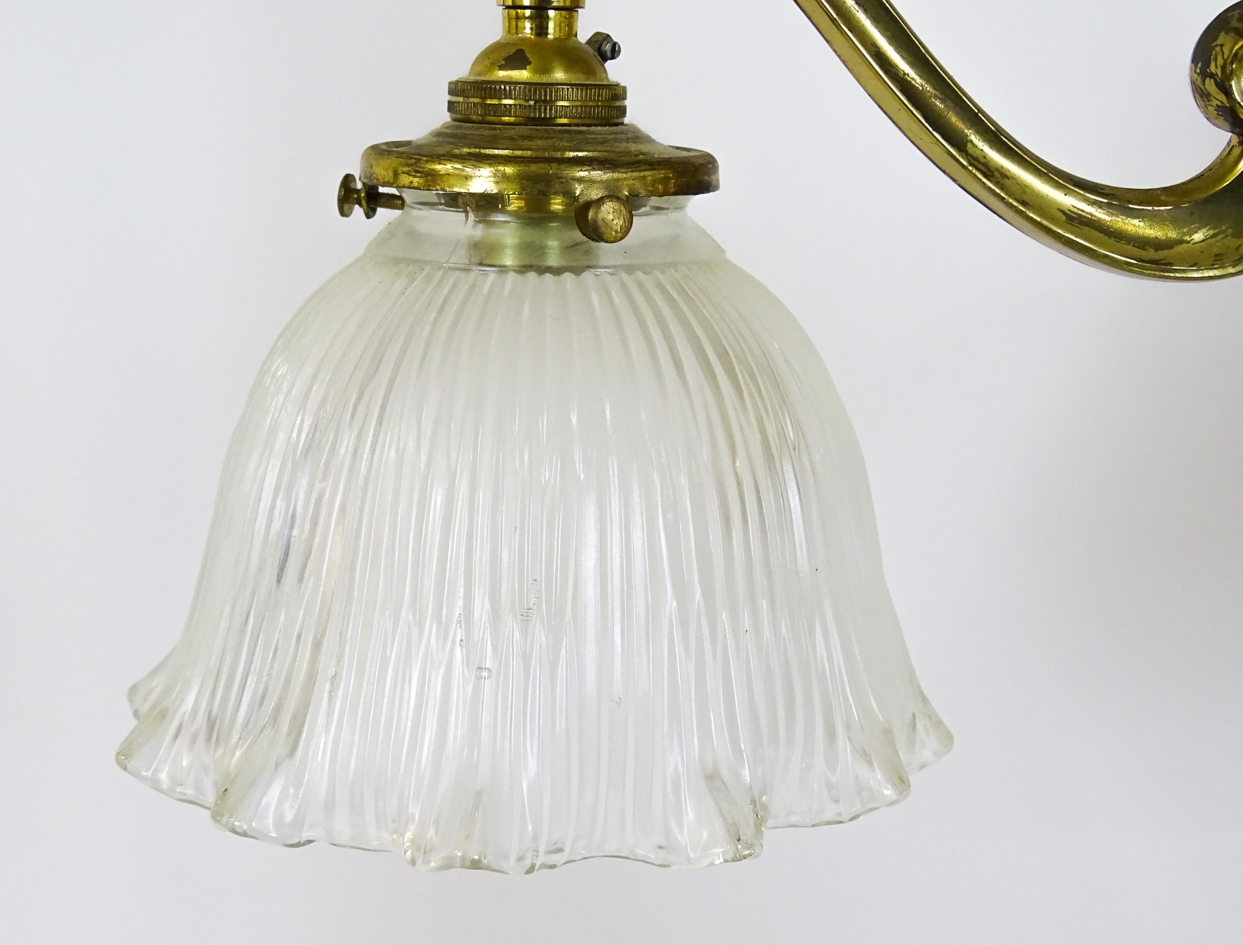 A pair of brass pendant lights having three scrolling branches with three holophane shades. - Image 16 of 16