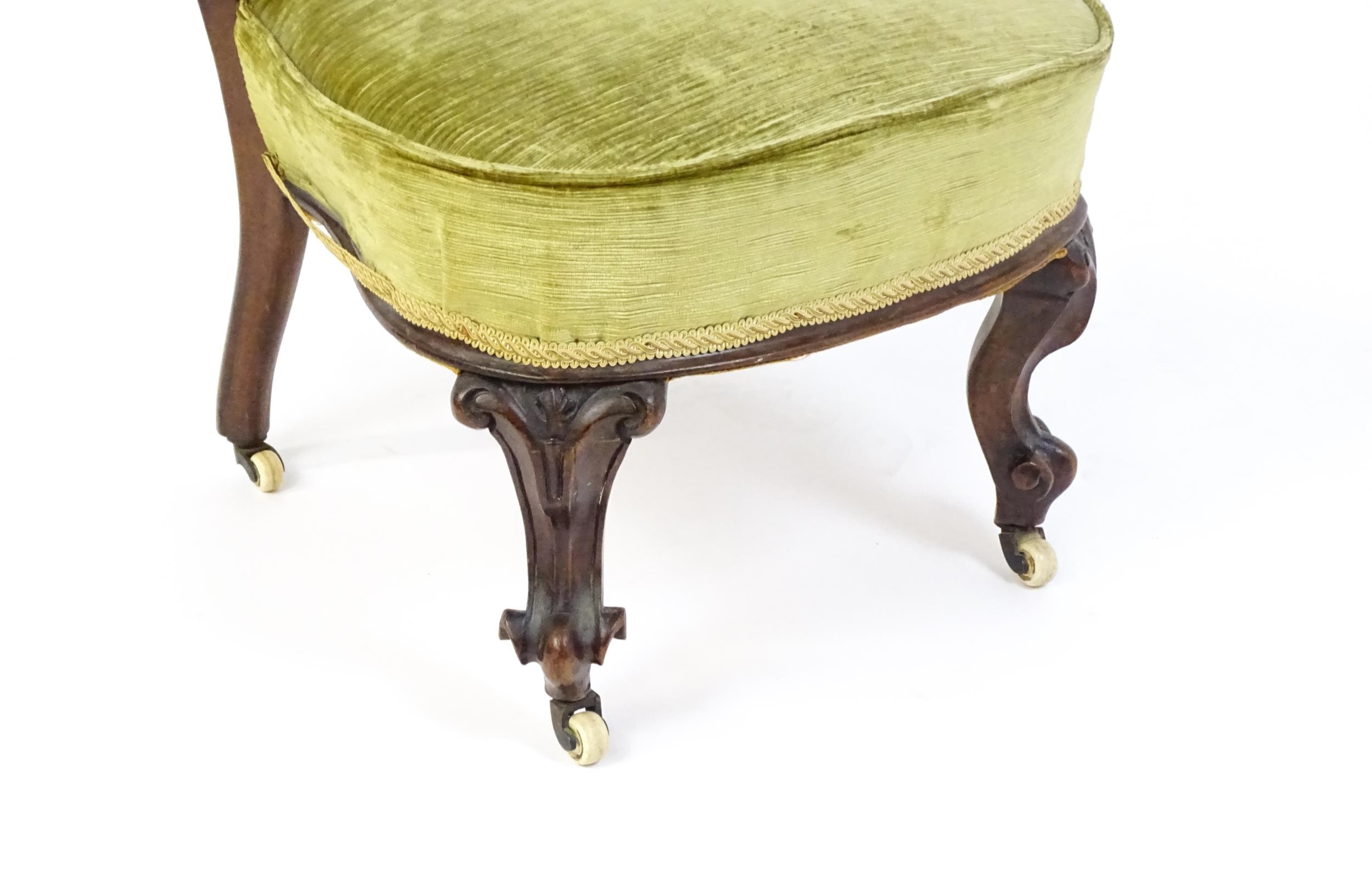 A mid / late 19thC mahogany nursing chair with a pierced, carved floral top rail above moulded - Image 3 of 6