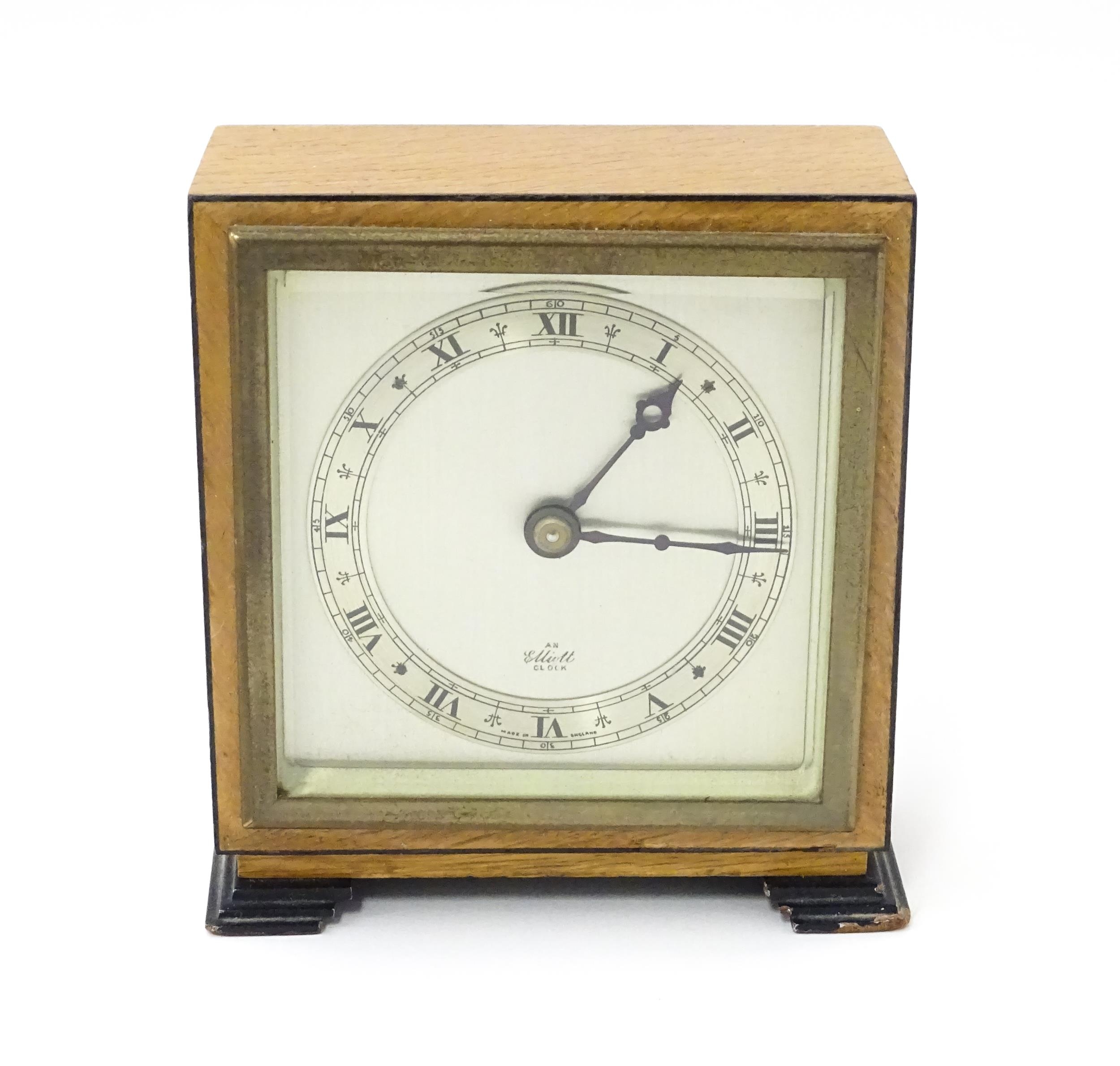 A 20thC mantle clock by Elliott. the dial with Roman numeral chapter ring and signed ' An Elliott