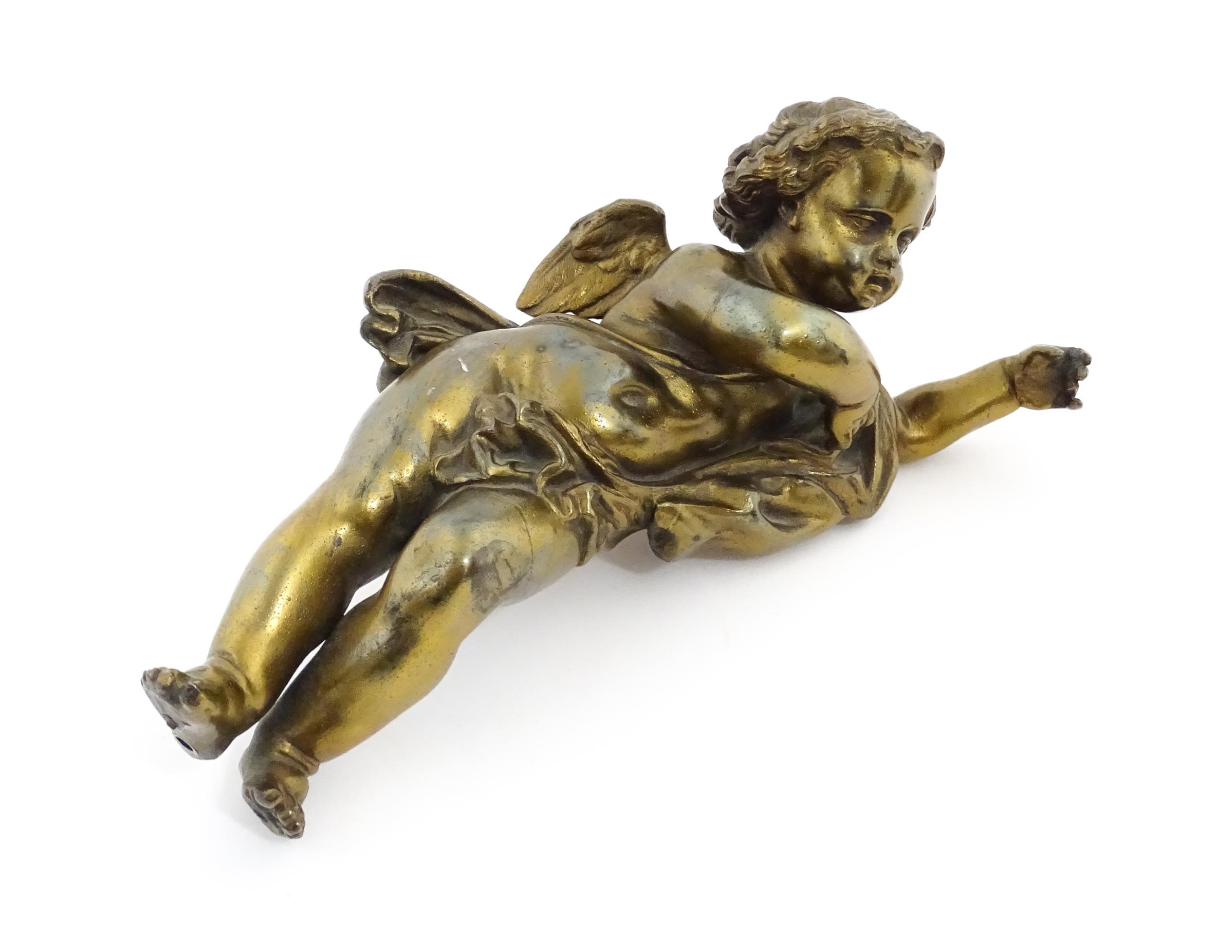 A 20thC cast model of a winged putto / cherub. Approx. 11" long Please Note - we do not make - Image 3 of 6