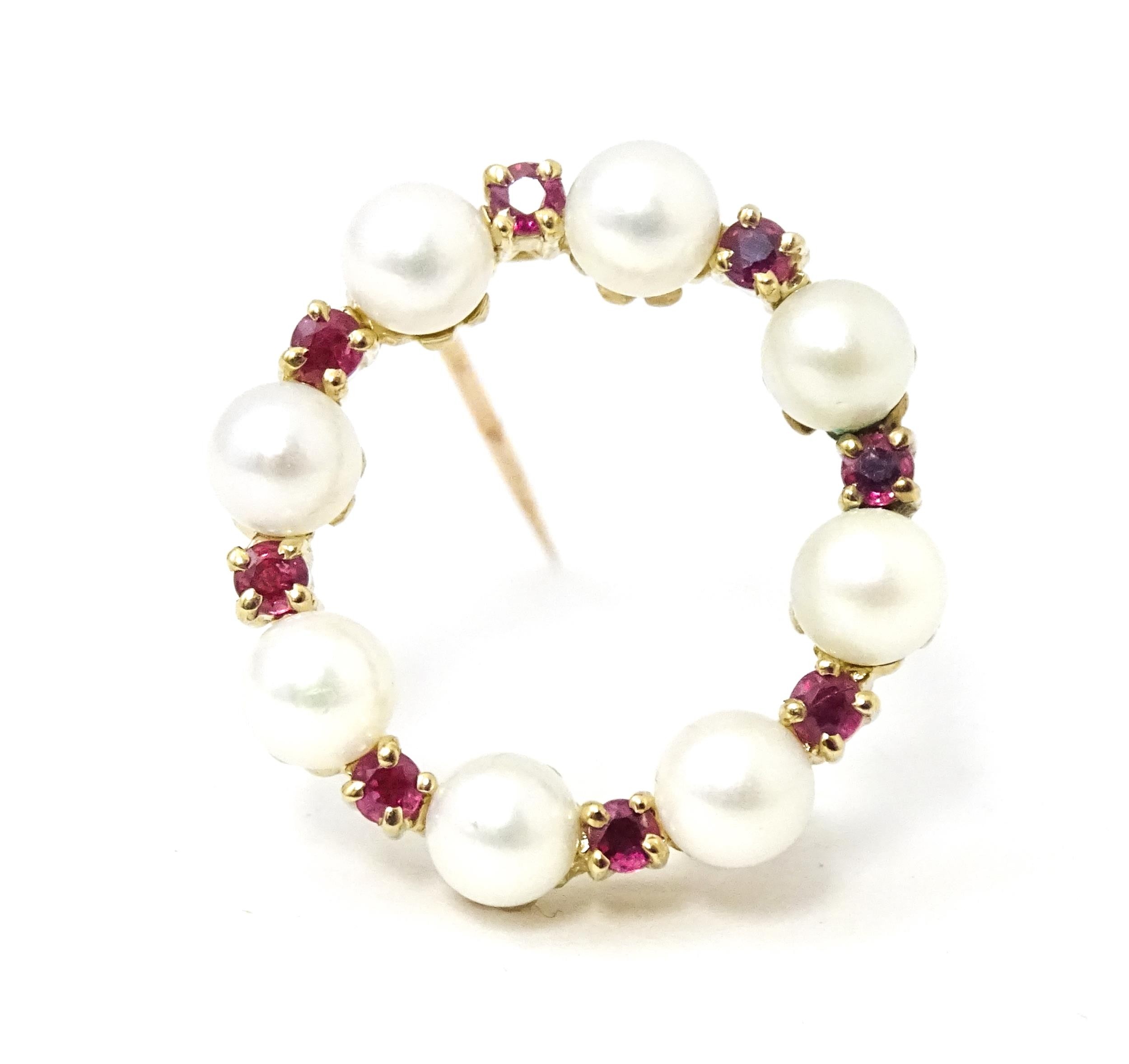 A 9ct gold pendant / brooch of circular set with pearls and round cut rubies. Approx 1" wide - Image 2 of 9