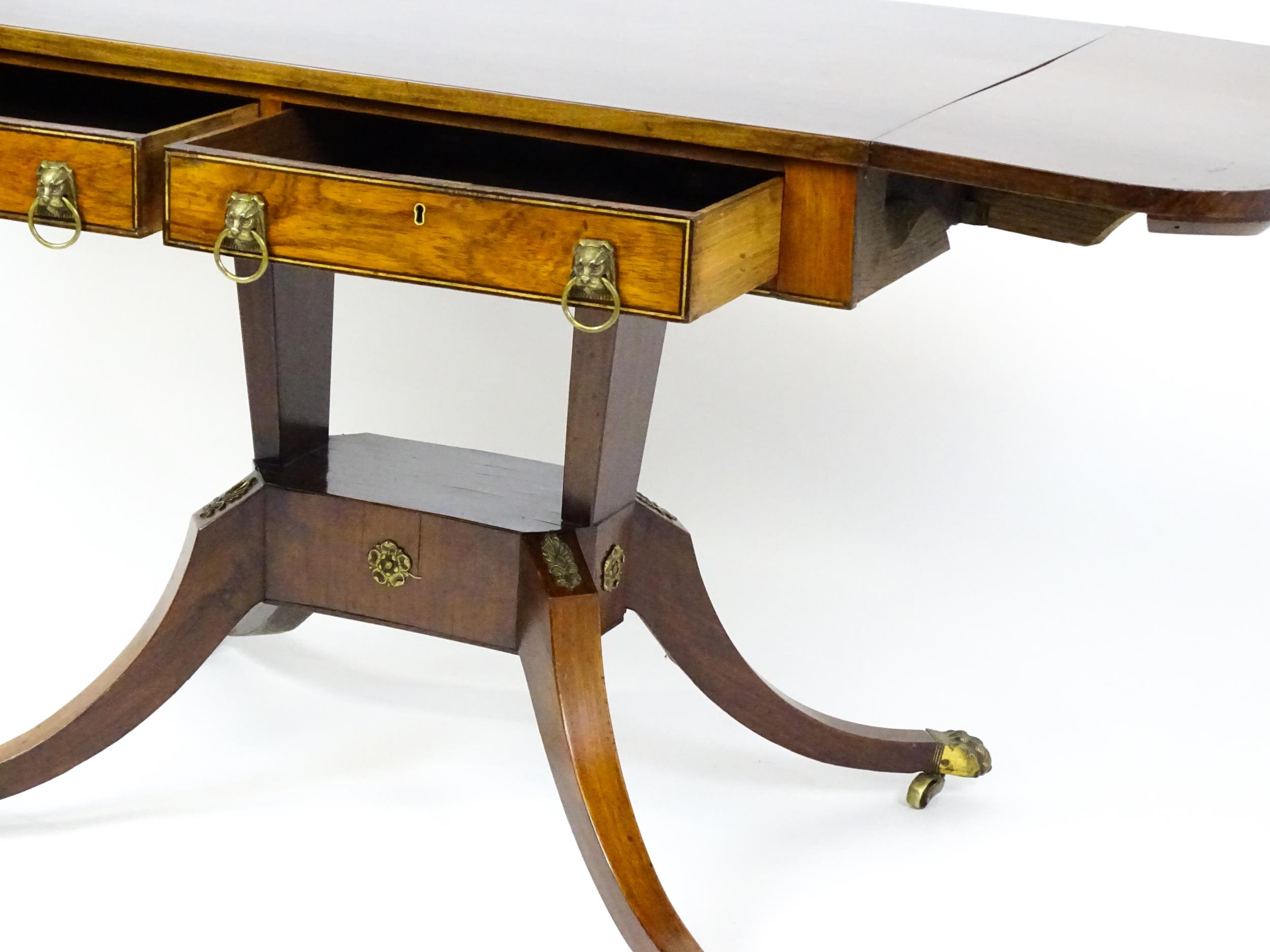 A 19thC and later sofa table with drop flaps to either side, two small frieze drawers opposing two - Image 9 of 10