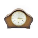 A 20thC smiths walnut cased mantle clock with chiming movement. Approx. 8" high Please Note - we