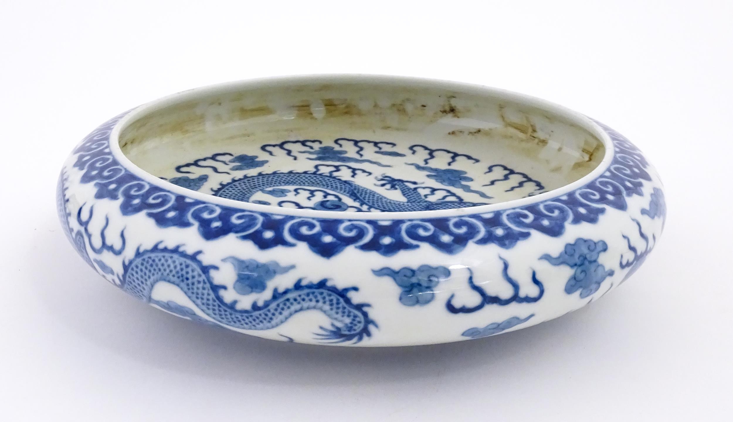 A Chinese blue and white dish decorated with dragons amidst clouds. Character marks under. Approx. - Image 5 of 8