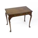 A George III mahogany side table with a moulded top above a single long frieze rawer with brass