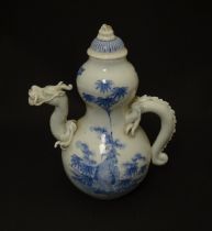 A Japanese Hirado style teapot of double gourd form the spout and handle modelled as a dragon, the