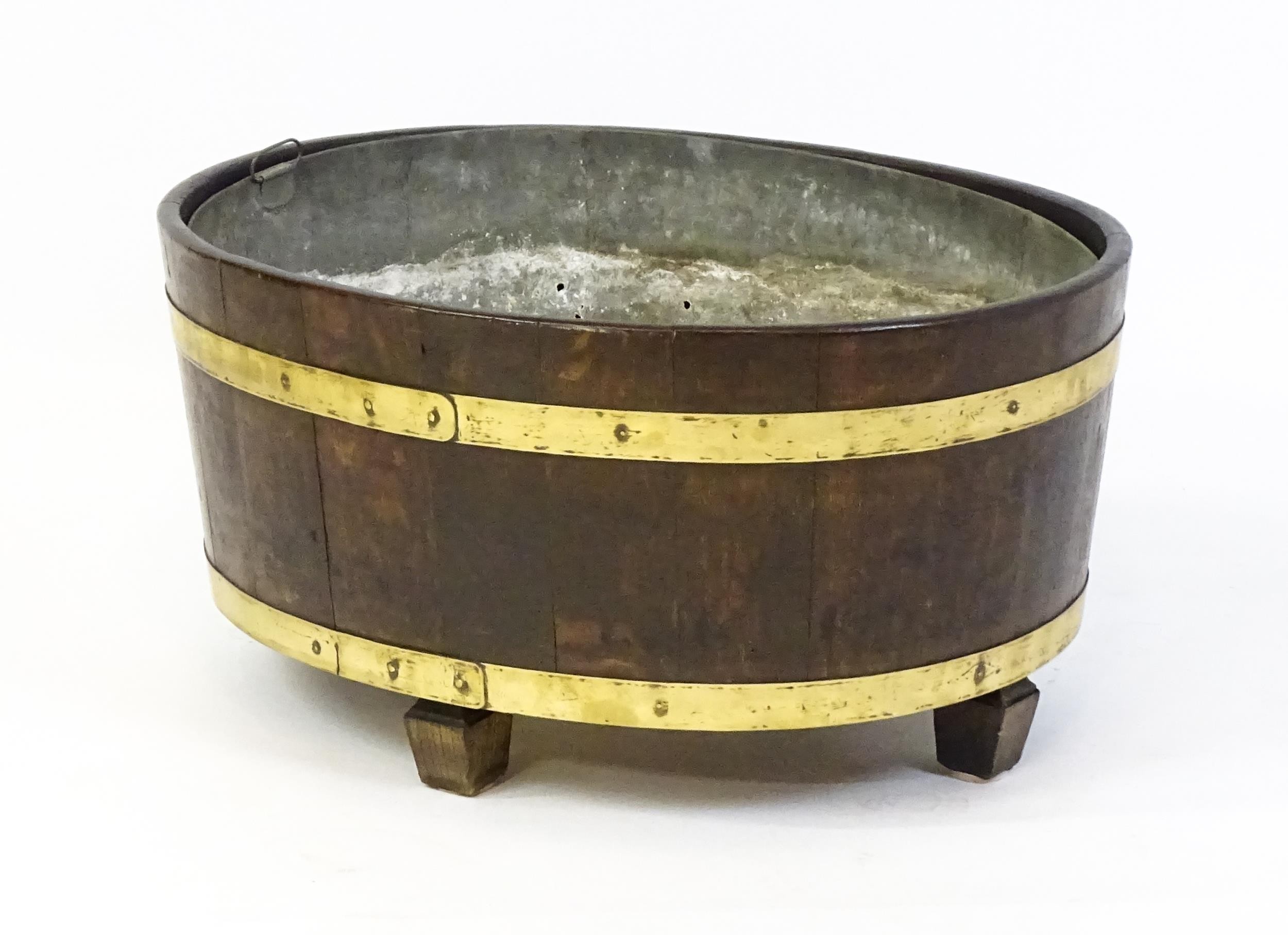 A late Georgian oak wine cooler / cellarette with a coopered and brass strapped frame and raised - Image 5 of 7