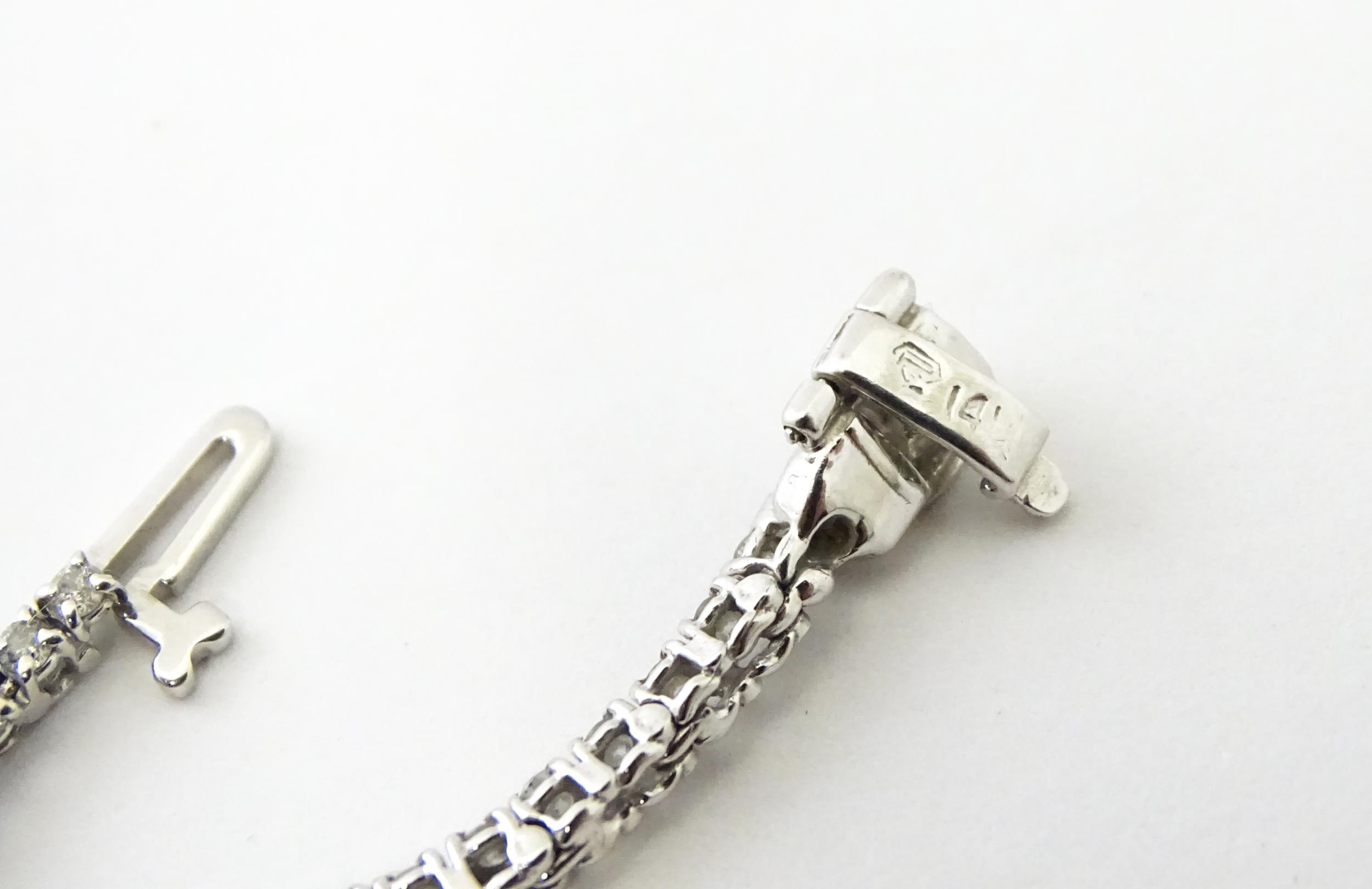 A 14ct white gold tennis bracelet set with diamonds. Approx 7 1/2" long Please Note - we do not make - Image 9 of 10