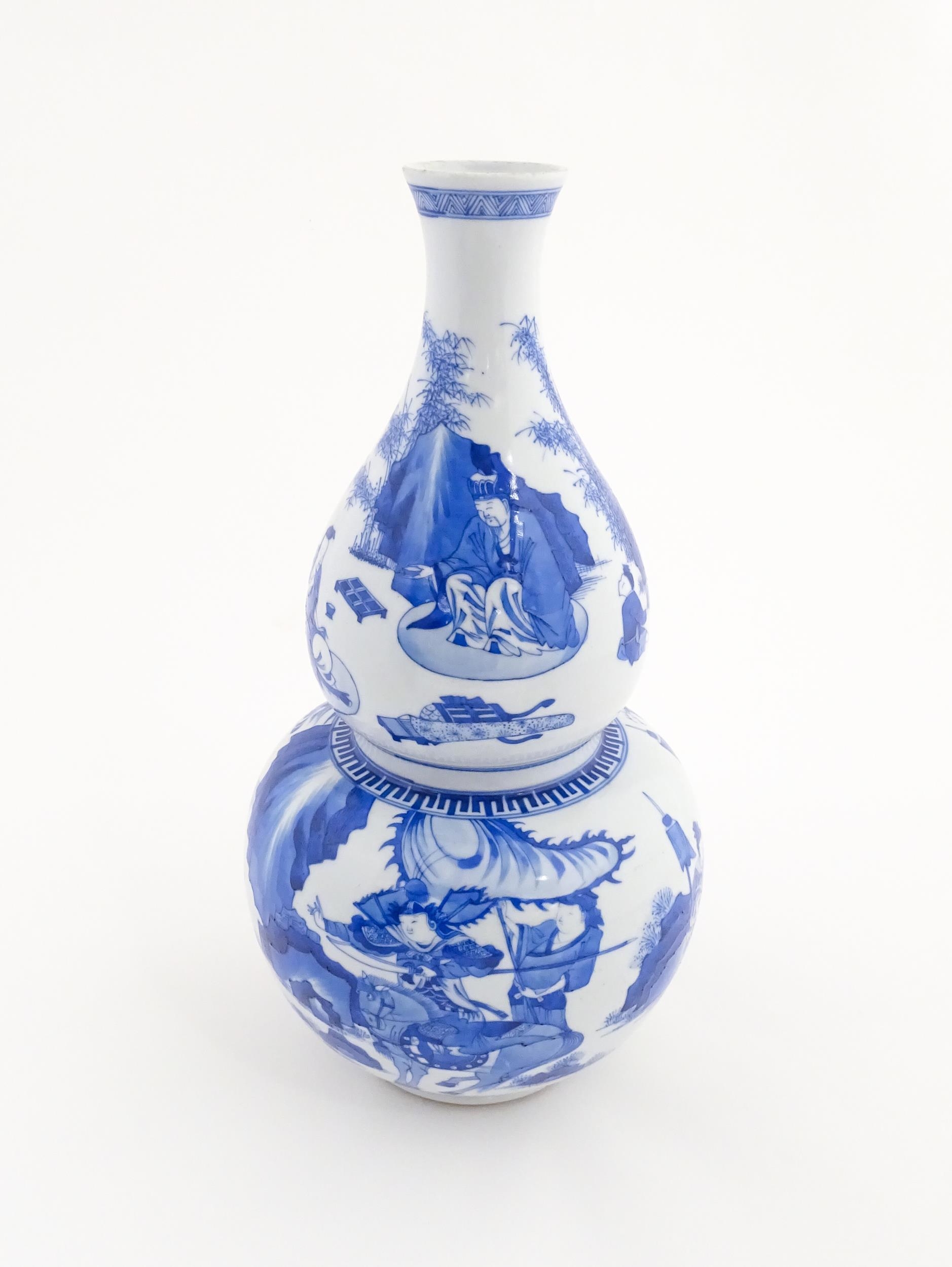 A Chinese blue and white double gourd vase decorated with figures in a landscape. Approx. 16 1/4" - Image 2 of 7