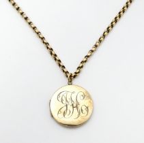 A 9ct gold and yellow metal chain set with circular yellow metal pendant locket. Pendant approx. 1