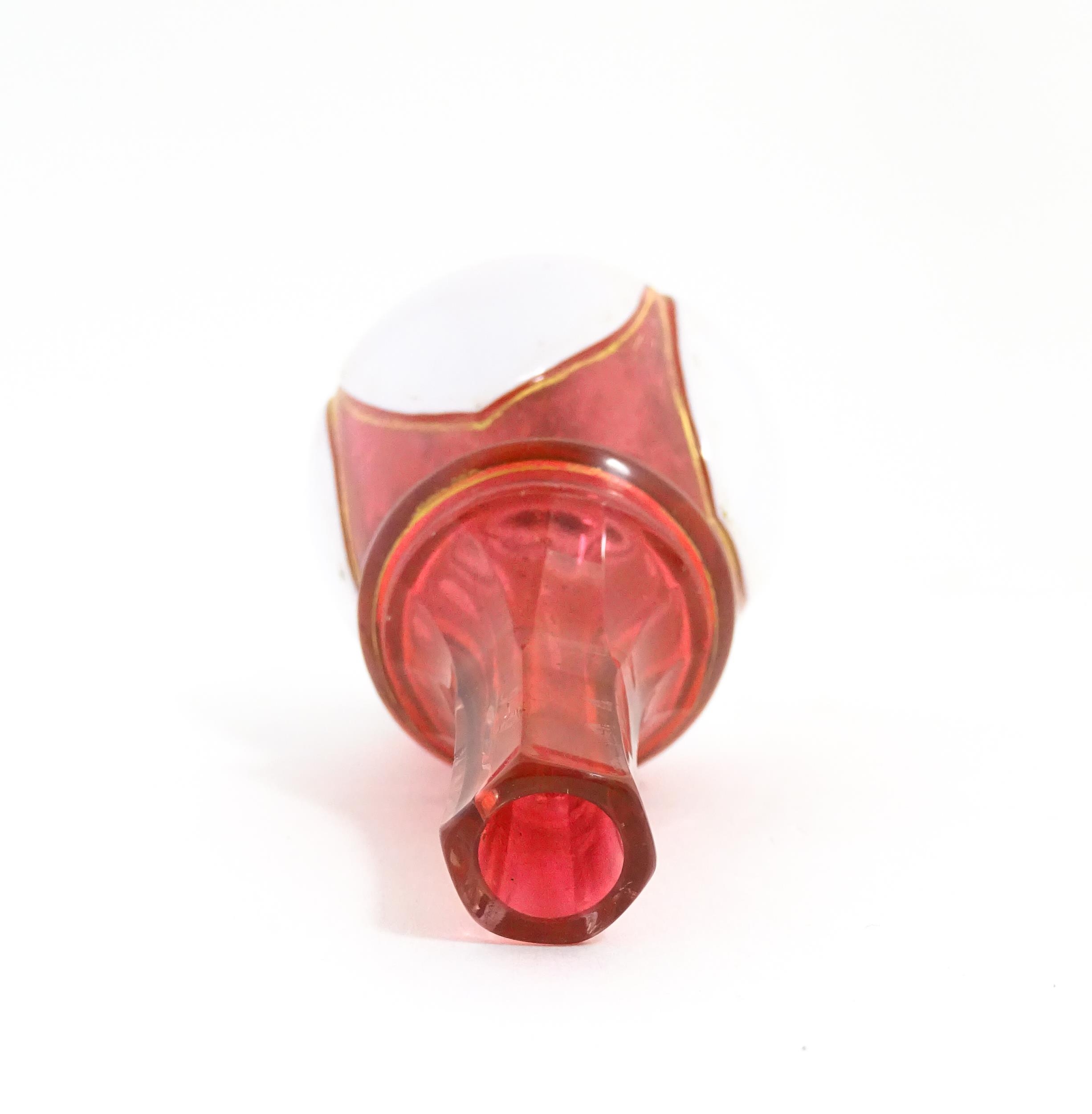 A small Bohemian style red and white glass bottle vase with gilt highlights. Approx. 3 3/4" high - Image 6 of 6