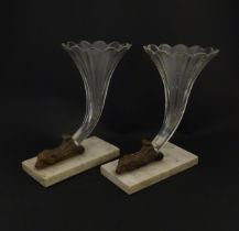A pair of Victorian epergnes the clear glass flutes with rams head support mounted on a