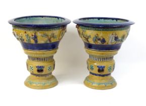 A pair of large Chinese pedestal planters / jardinieres on stands decorated with figures in a garden