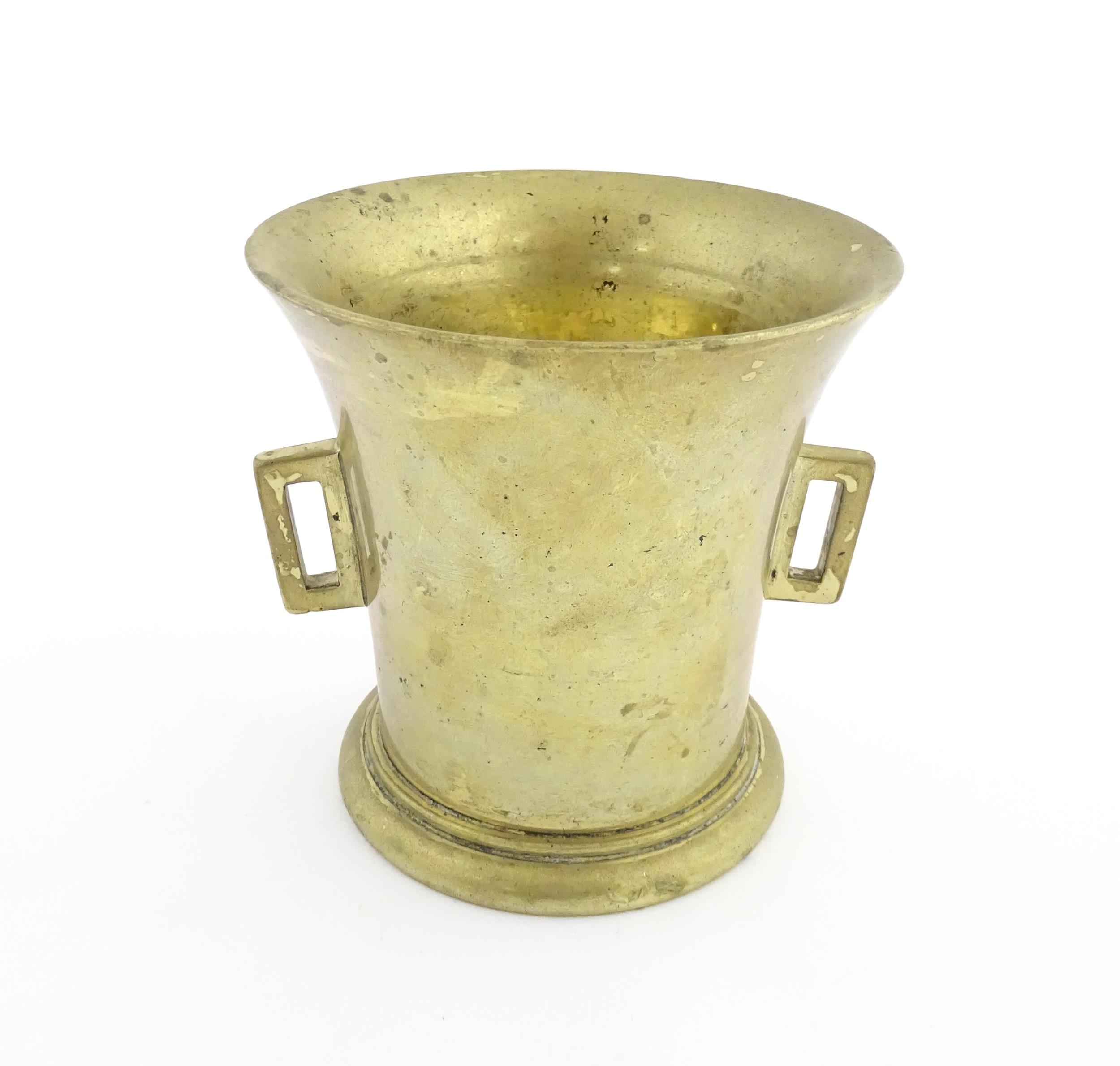 A 19thC brass pestle and mortar, the mortar of tapering form with twin rectangular handles. Mortar - Image 7 of 14