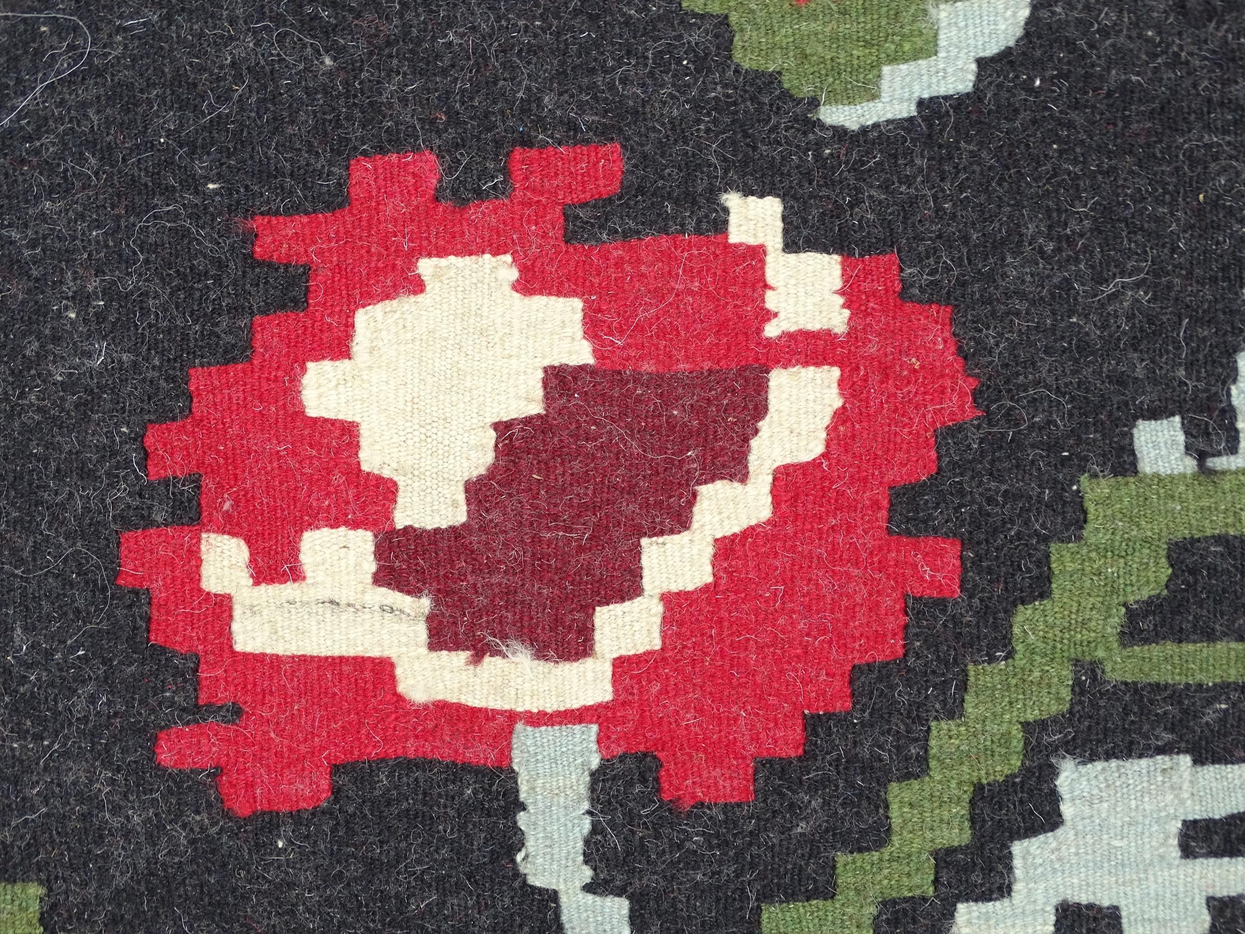 Carpet / Rug : A black ground rug with red floral decoration, with geometric motifs to borders. - Image 8 of 9