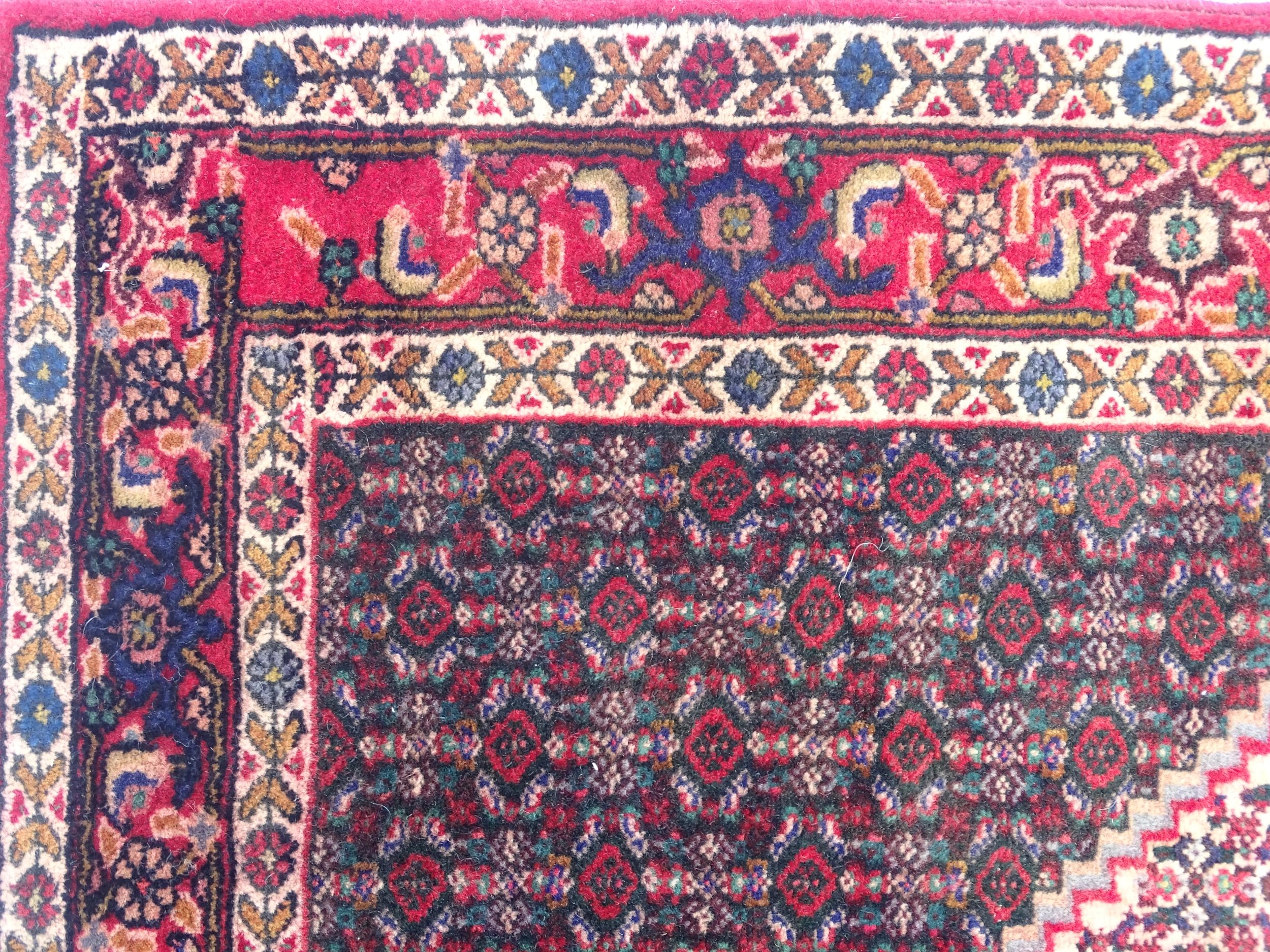 Carpet / Rug: A North West Persian Senneh rug, the red, blue and cream grounds decorated with - Image 3 of 7