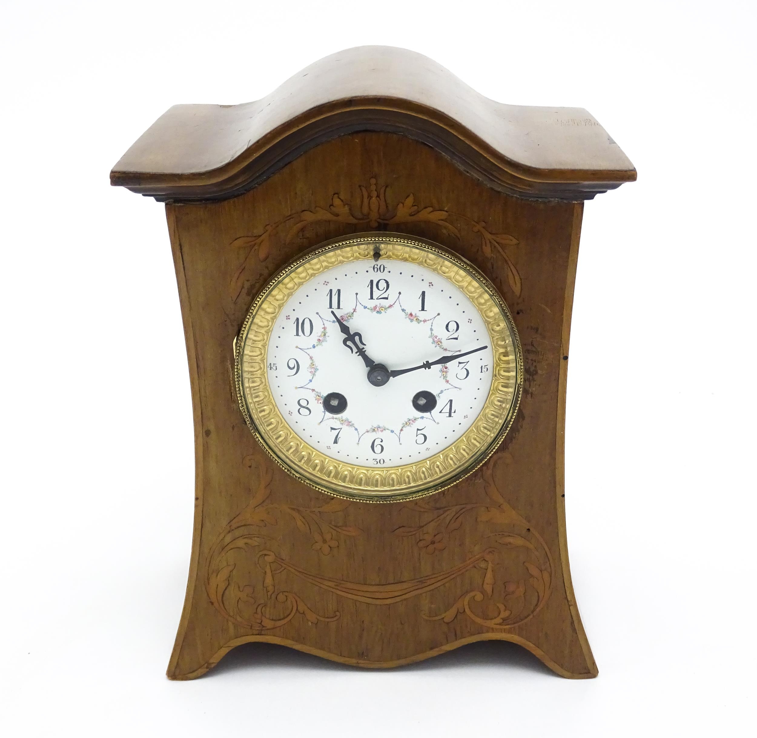 A late 19thC / early 20thC mahogany cased French mantle clock with satinwood inlay and white