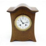 A late 19thC / early 20thC mahogany cased French mantle clock with satinwood inlay and white