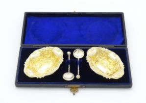 A pair of silver salts of shaped form with gilded interiors hallmarked Birmingham 1897. Together