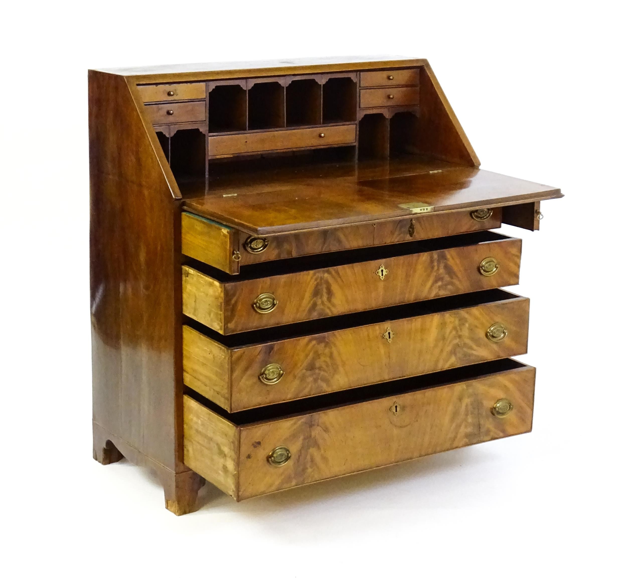 An early 19thC mahogany bureau with a fall front above four long graduated drawers with brass back - Image 3 of 6