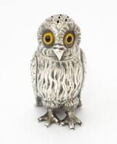 A Victorian silver novelty pepperette modelled as an owl with glass eyes, hallmarked London 1853,