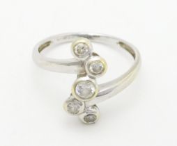 A 14ct white gold ring set with five white stones. Ring size approx. U Please Note - we do not