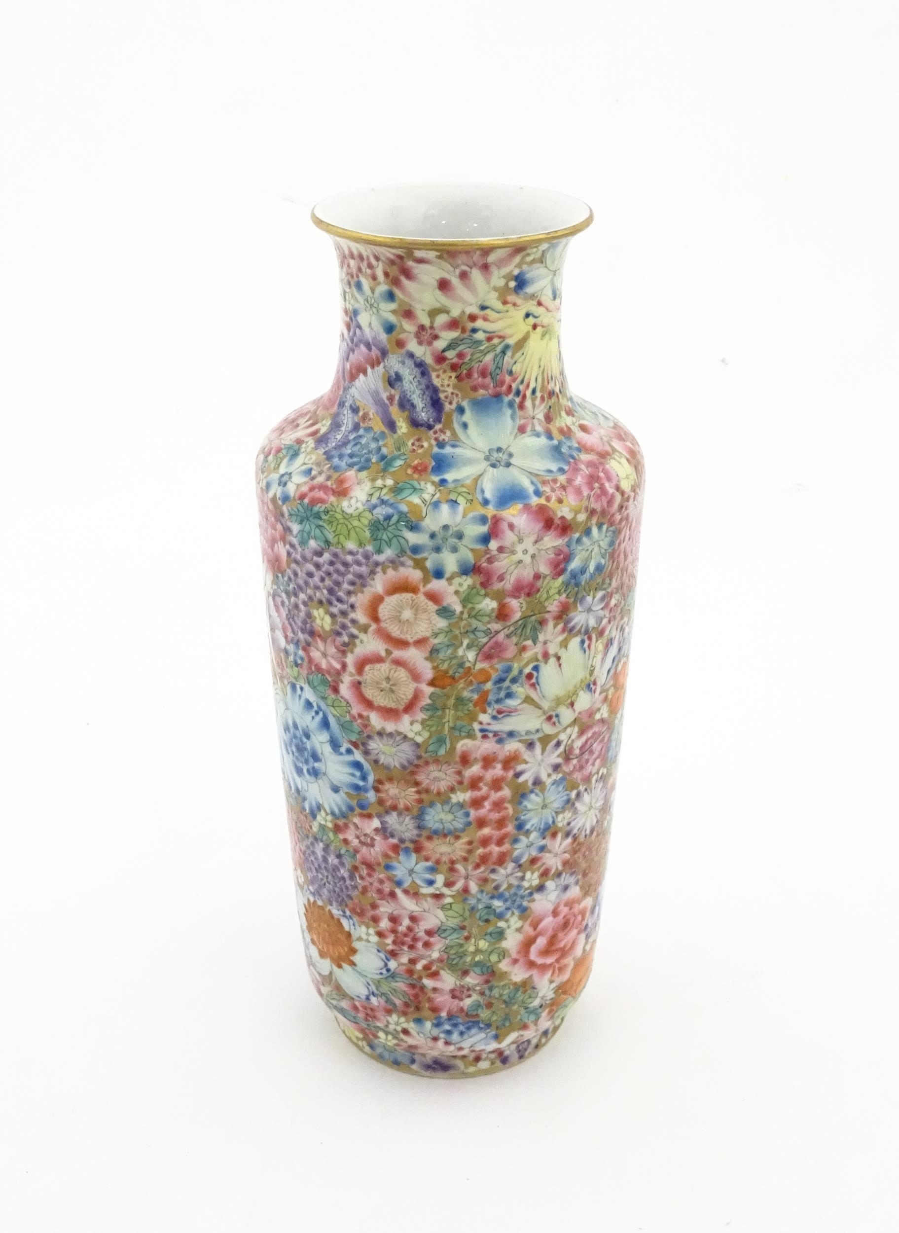 A Chinese famille rose vase decorated with a profusion of flowers. Character marks under. Approx. 10