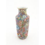 A Chinese famille rose vase decorated with a profusion of flowers. Character marks under. Approx. 10