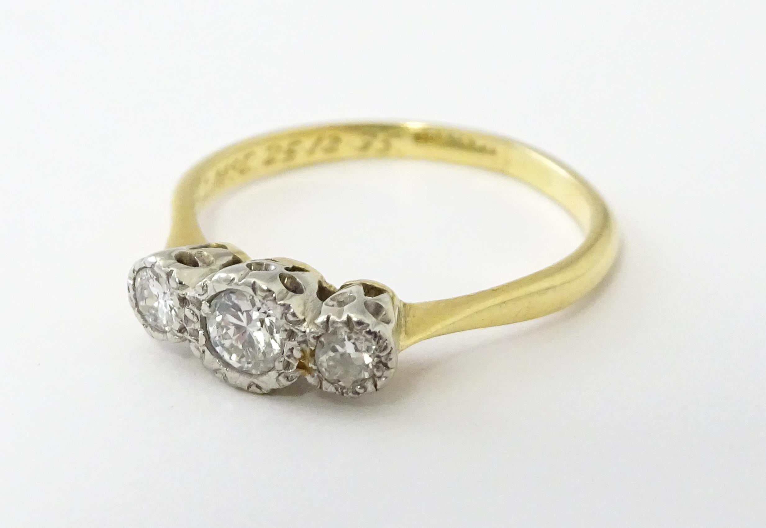 An 18ct gold ring with three platinum set diamonds. Ring size approx. O Please Note - we do not make - Image 6 of 18