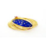 An 18ct gold brooch with blue enamel detail flanked by pink stones. Approx 2 wide Please Note - we