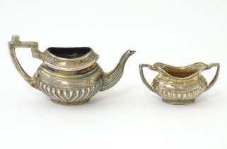 A miniature / dolls house silver twin handled teapot and sugar bowl hallmarked Birmingham 1988,