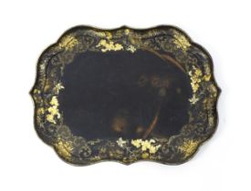 A Victorian papier-mache tray with a moulded edge and gilt painted floral decoration. Stamped B.