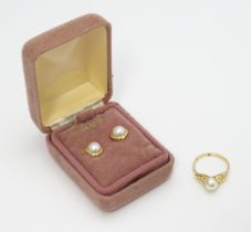 A 14ct gold ring set with central pearl. Ring size approx. M. Together with a pair of stud