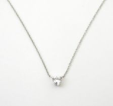 A Platinum necklace set with diamond pendant. The diamond approx 1/8" diameter. The necklace