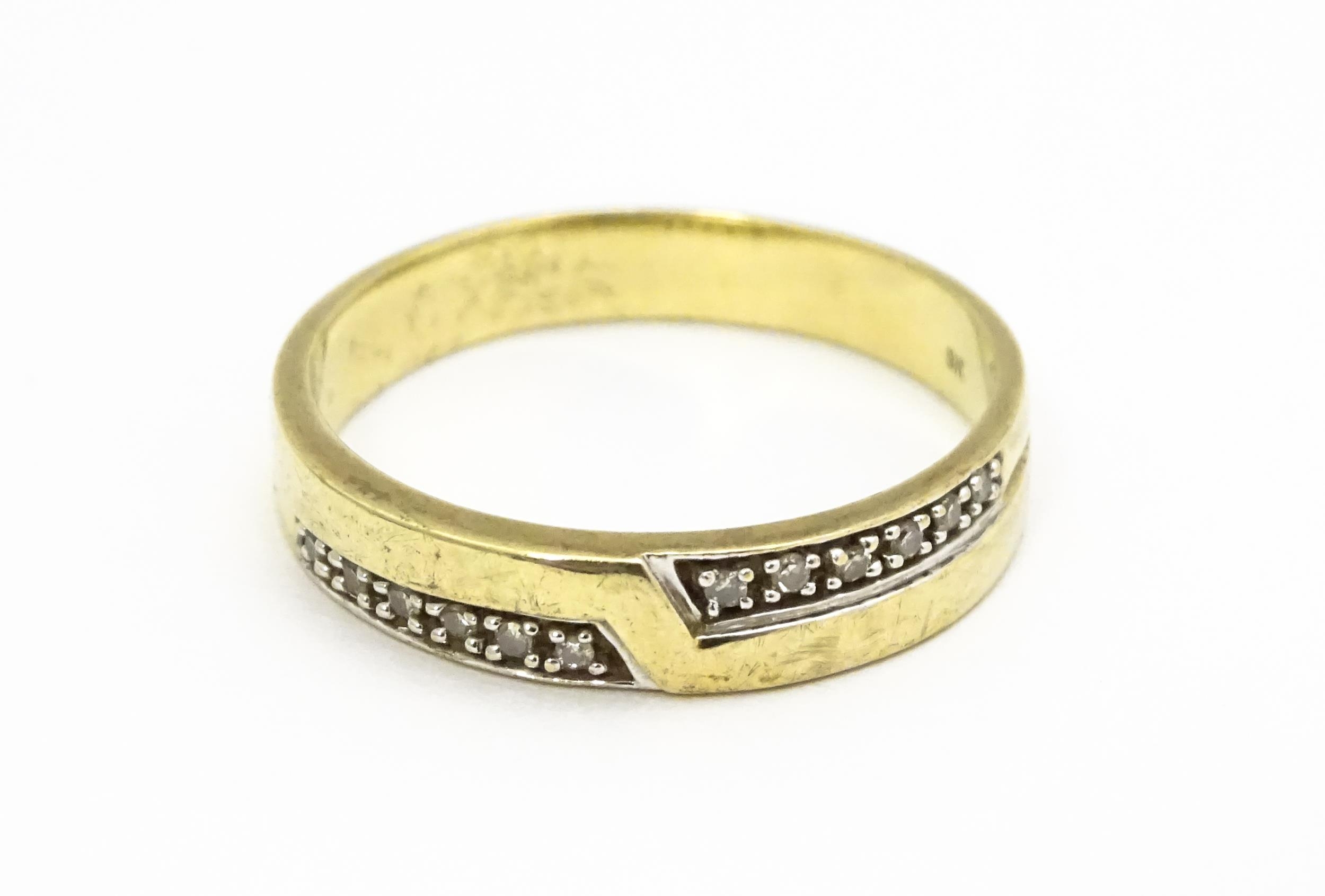 A 9ct gold ring set with white stones in white metal settings. Ring size approx. T Please Note -