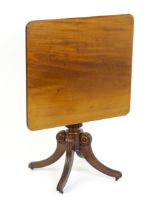 A 19thC mahogany occasional table, with a reeded tapering pedestal and raised on four reeded legs