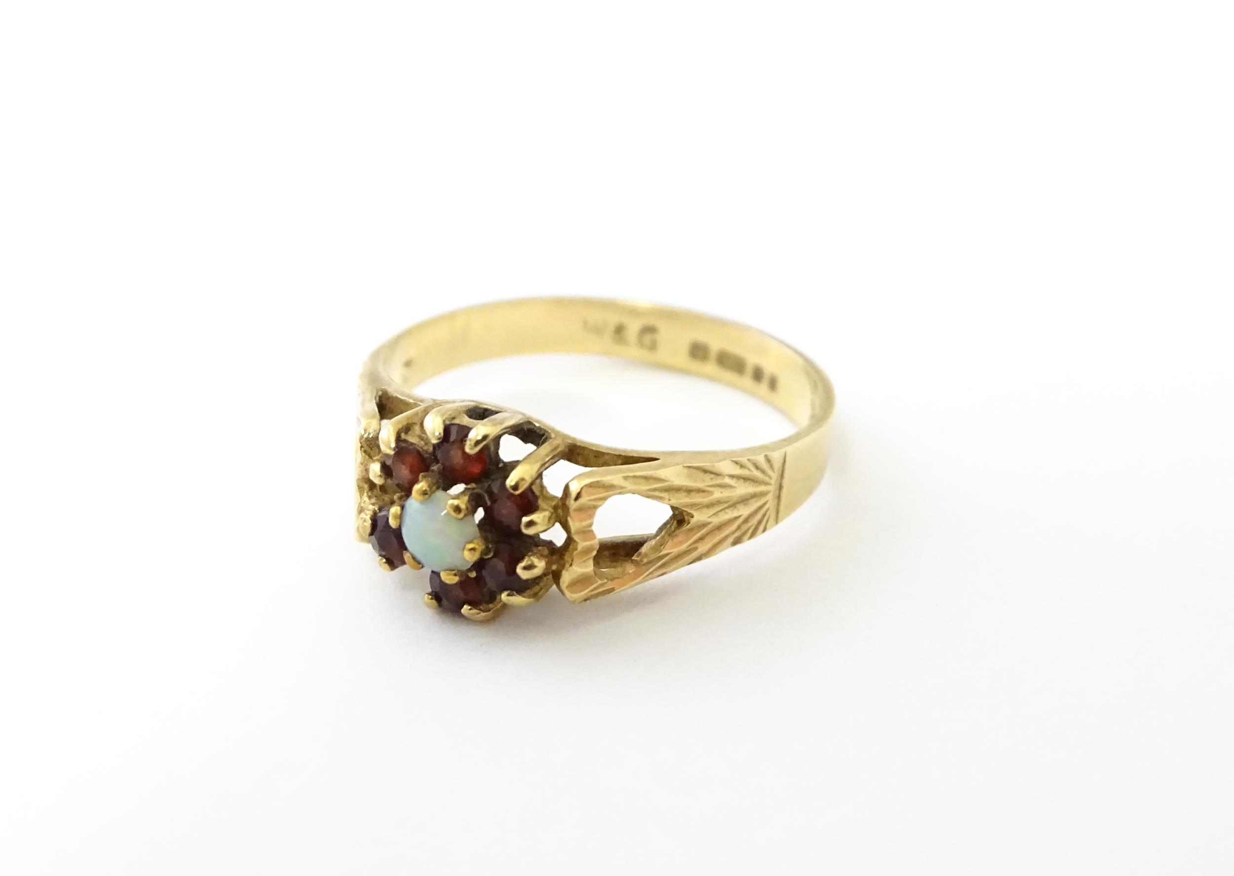 A 9ct gold ring set with central opal bordered by 6 garnets. Ring size approx. L Please Note - we do - Image 5 of 8