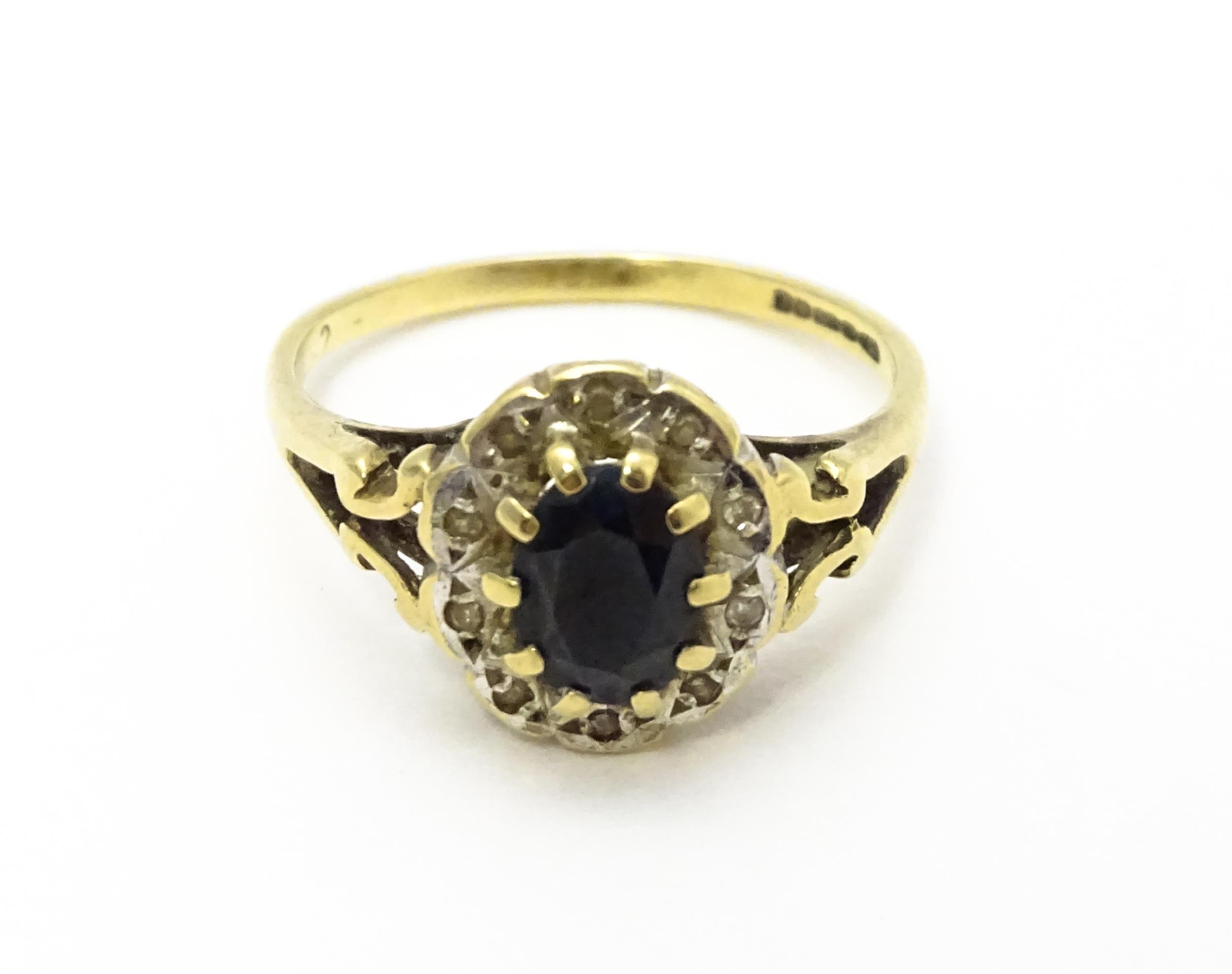 A 9ct gold ring set with central sapphire bordered by diamonds. Ring size approx. L 1/2 Please - Image 4 of 10