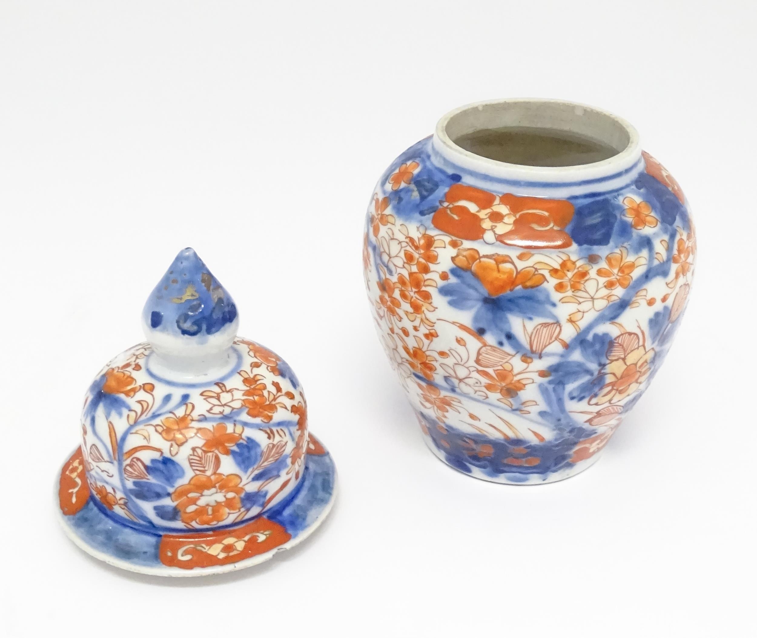 An Oriental ginger jar decorated in the Imari palette with flowers and foliage. Approx. 7 1/2" - Image 3 of 7