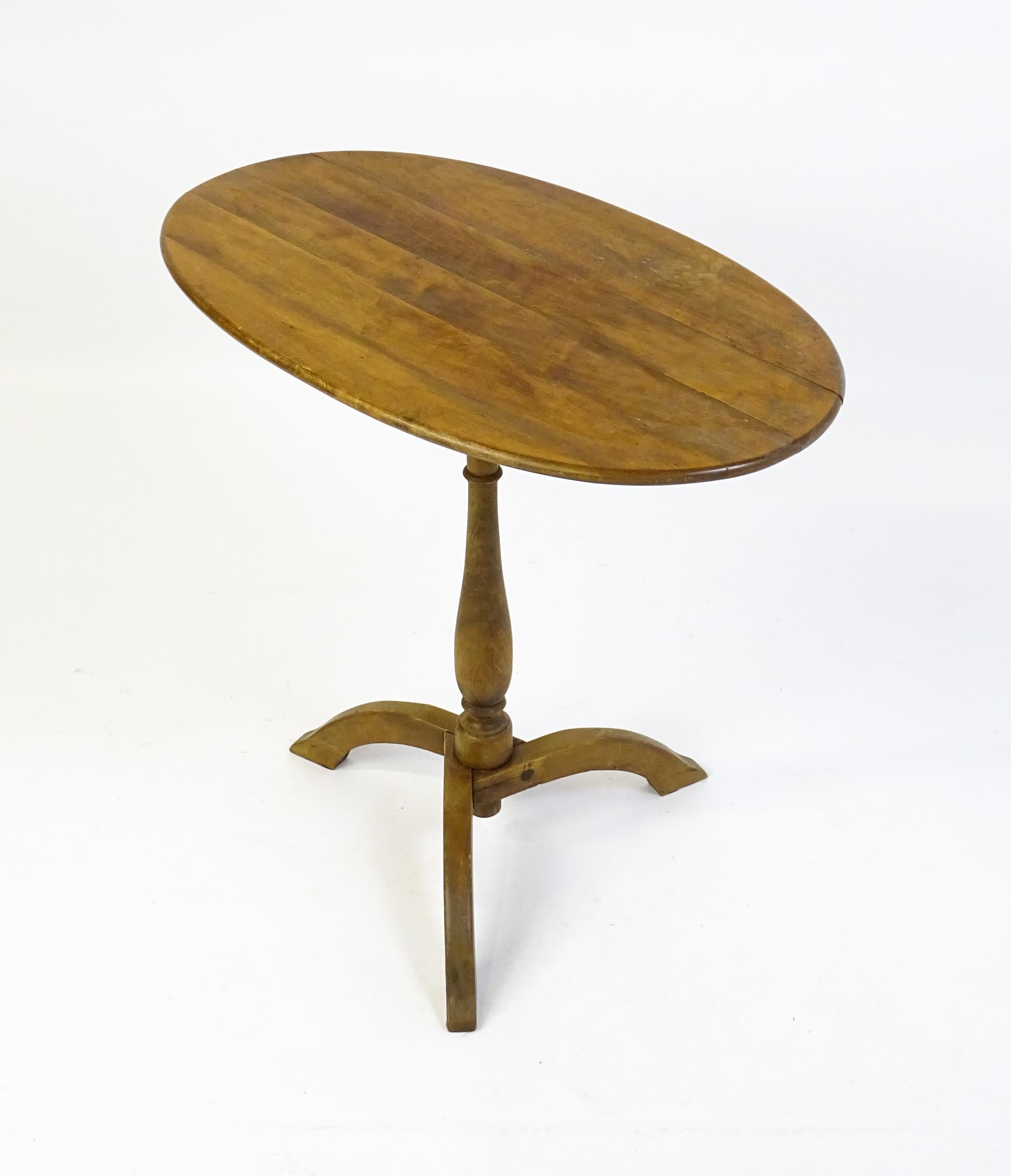 An early 20thC New England style occasional table, with an oval planked top, a storage compartment - Image 6 of 6