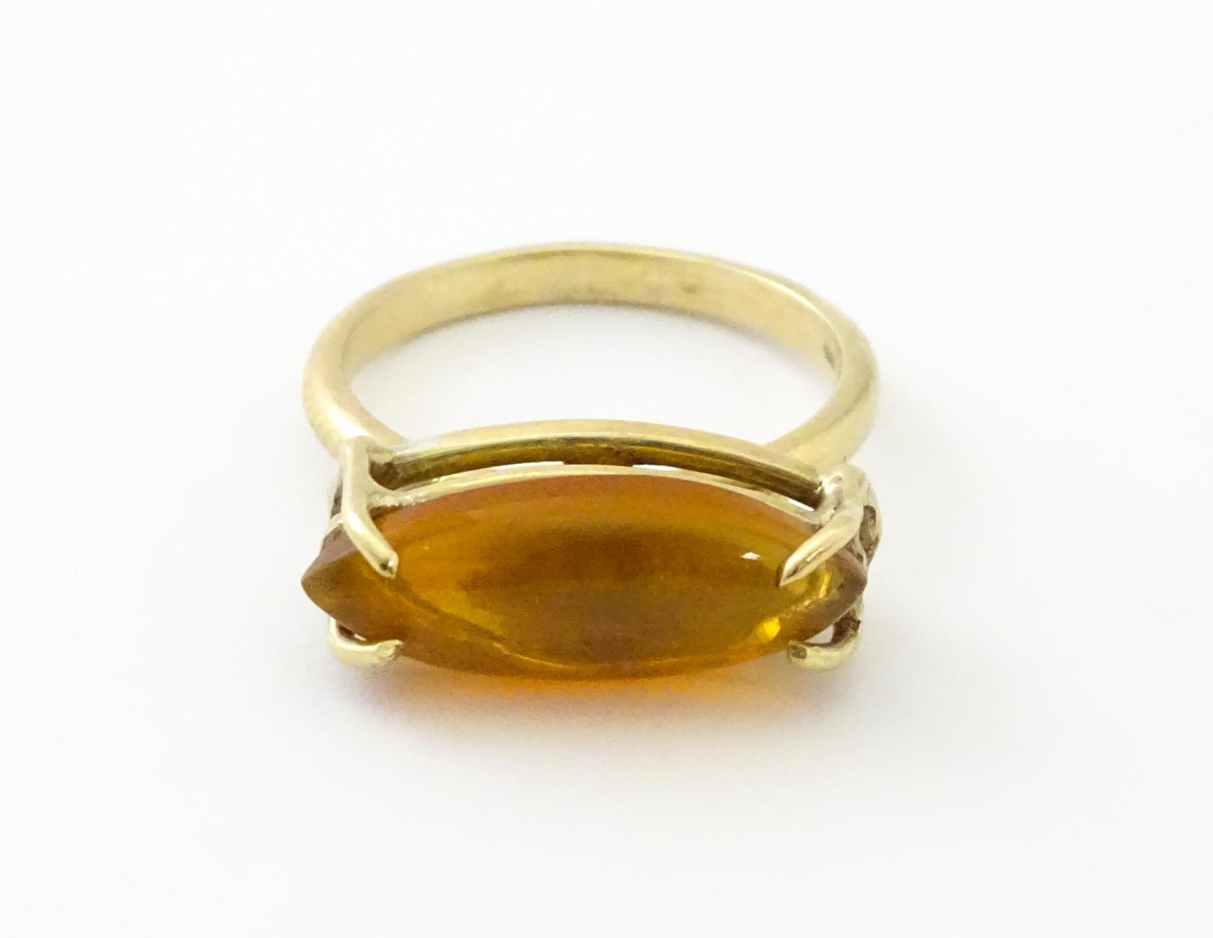 A 9ct gold ring with fire opal approx 3/4" long. Ring size approx. M Please Note - we do not make