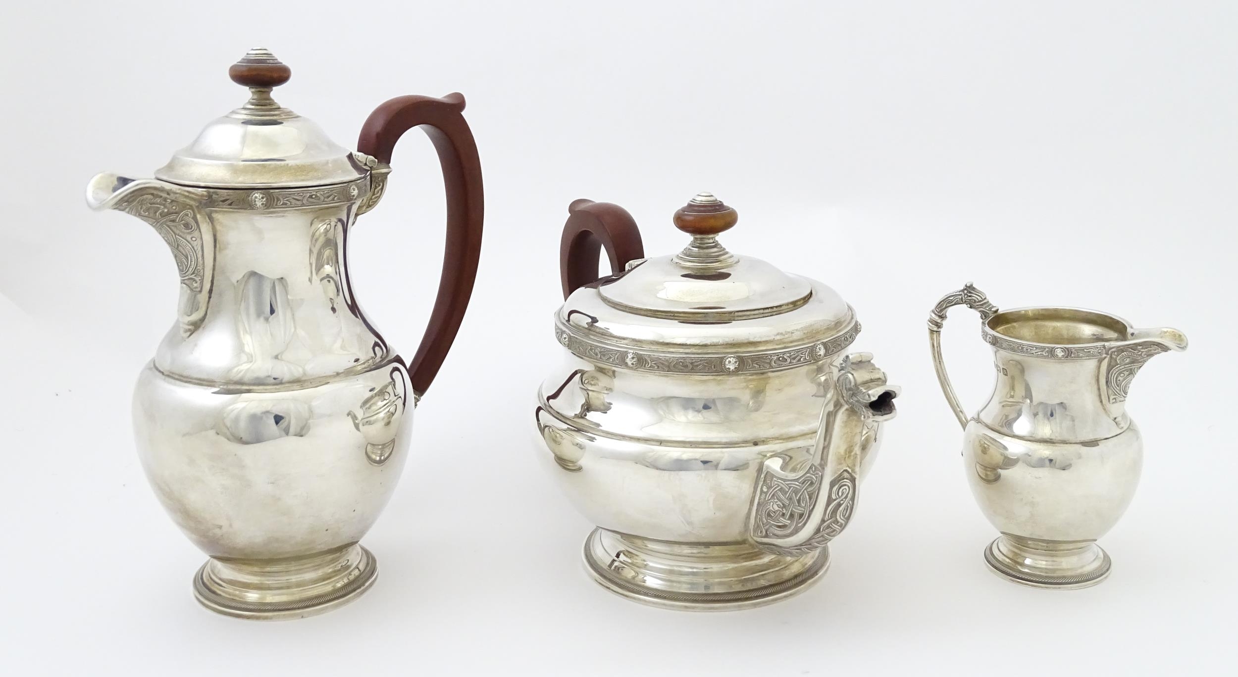 A three piece silver tea set comprising teapot, hot water pot and cream jug, with Celtic style - Image 3 of 20