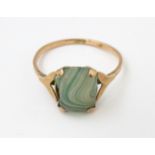 A 9ct gold ring set with green banded detail. Ring size approx. N 1/2 Please Note - we do not make