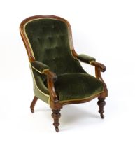 A 19thC mahogany open armchair, the spoon back design having a moulded frame and deep buttoned